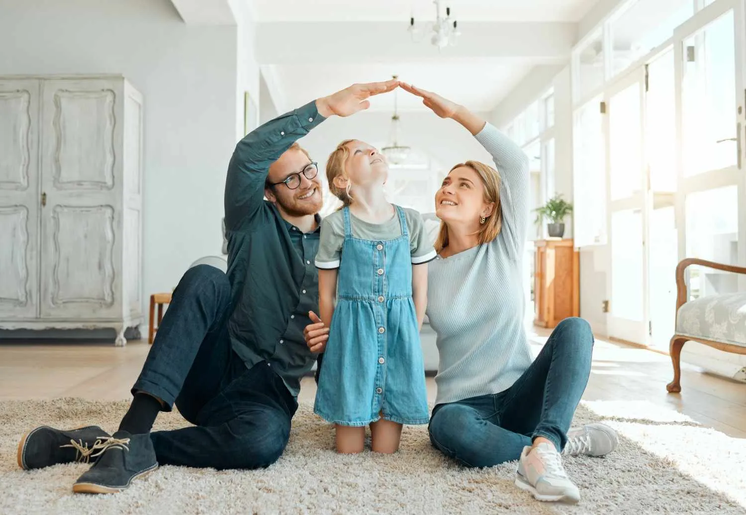 Family sitting together on the floor of a bright living room