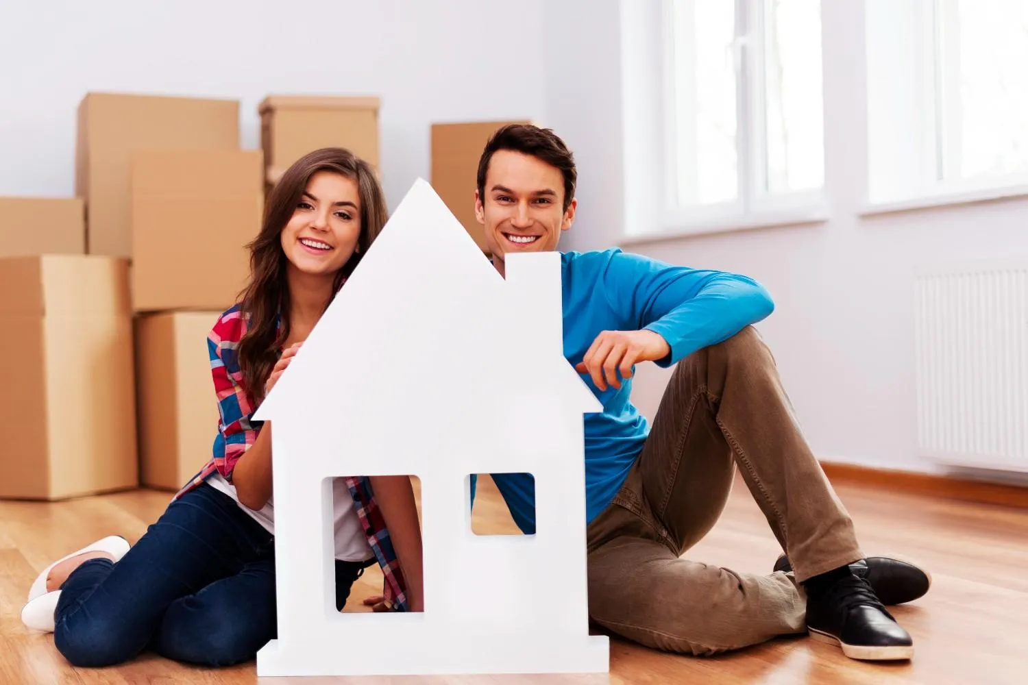 Homeowners settling into a new house surrounded by moving boxes
